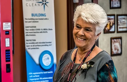 Mary Ausloos smiling at the Brownsville Headquarters