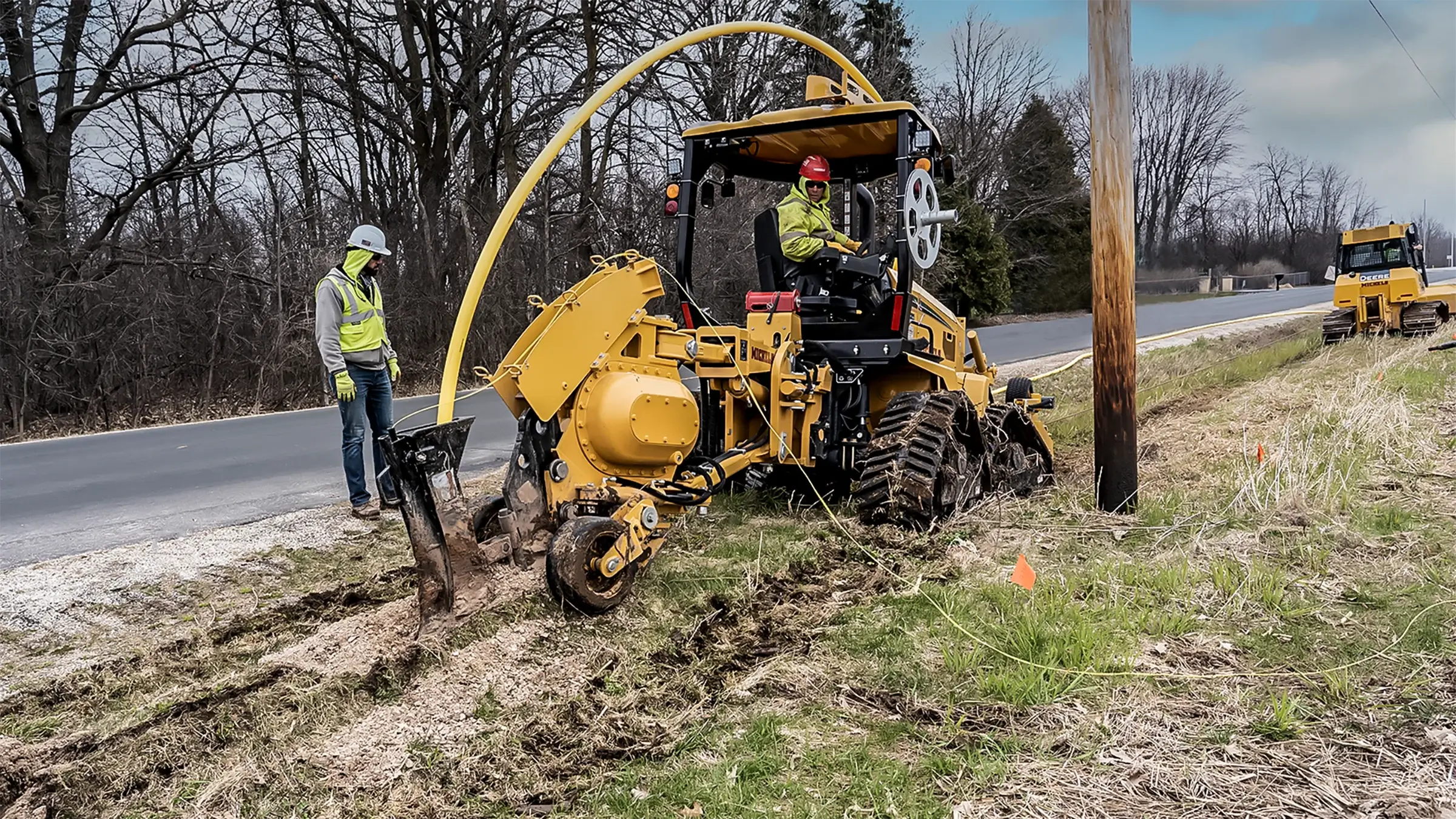 Morgan Luis uses a plow rig to bury plastic gas distribution pipe along a roadway