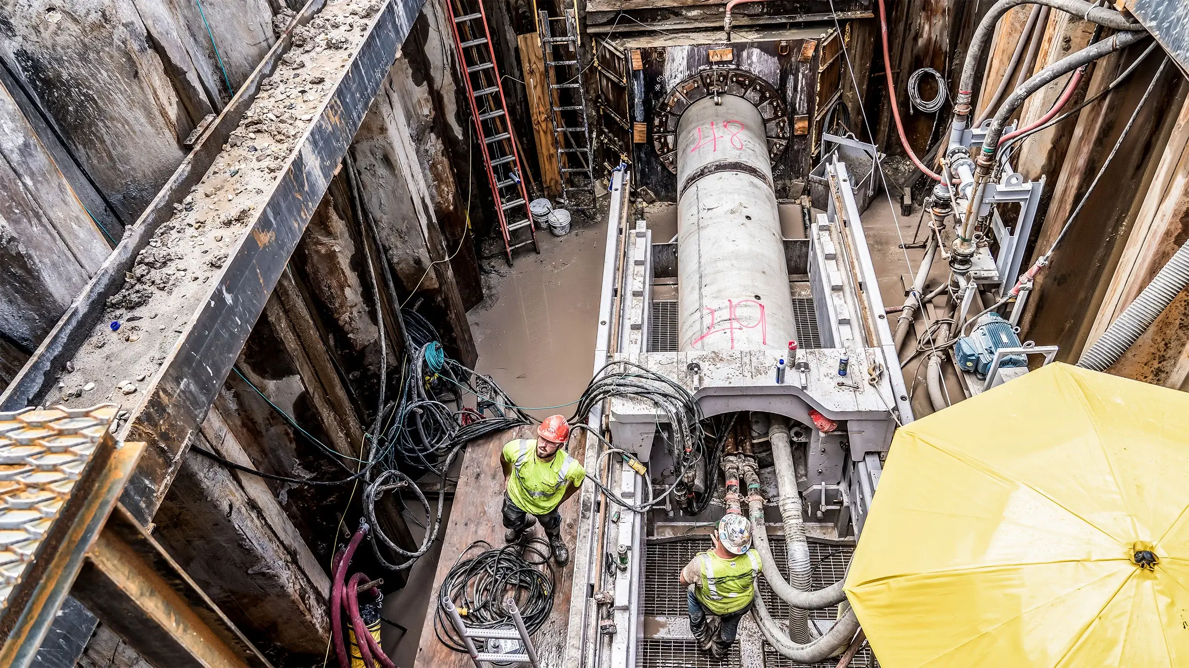 Two Michels crew members work near a microtunneling rig.