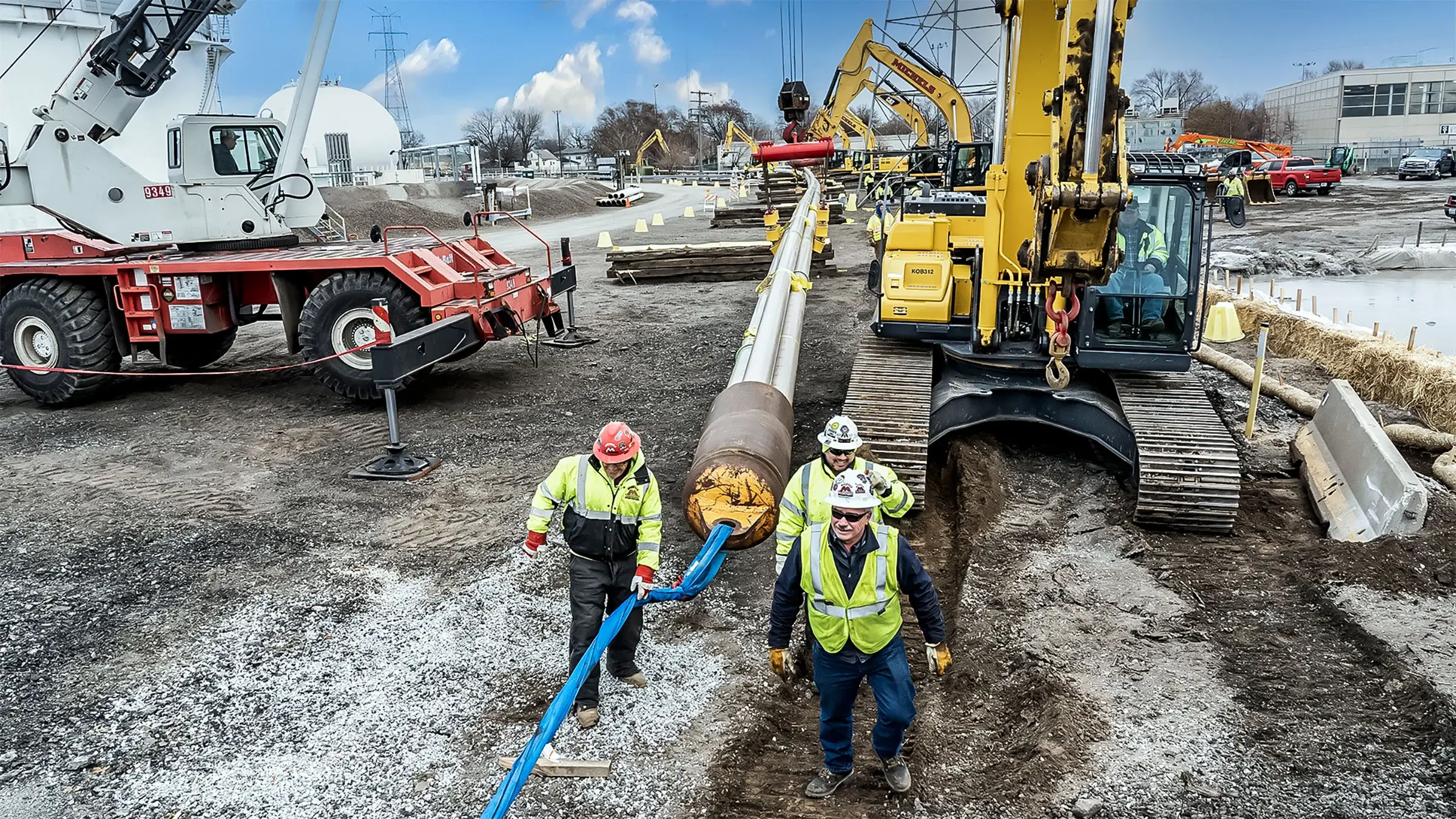 3 people walk along an HDD guide line
