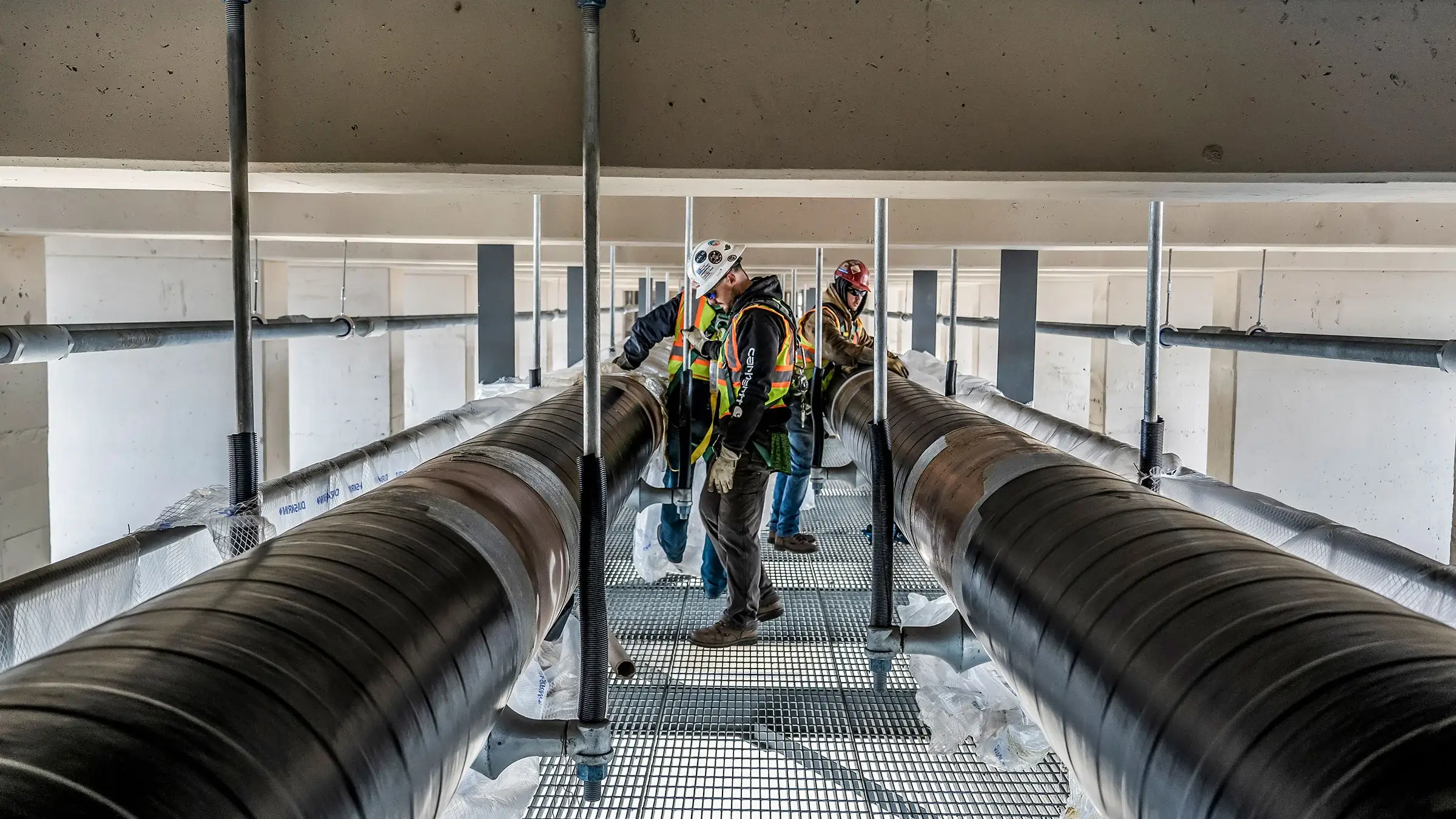 Michels Utility Services crew inspects newly installed natural gas pipelines under bridge in Minneapolis Minnesota