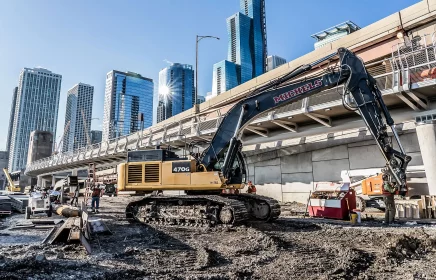 A Michels excavtor near a Chicago bridge and skyscrapers