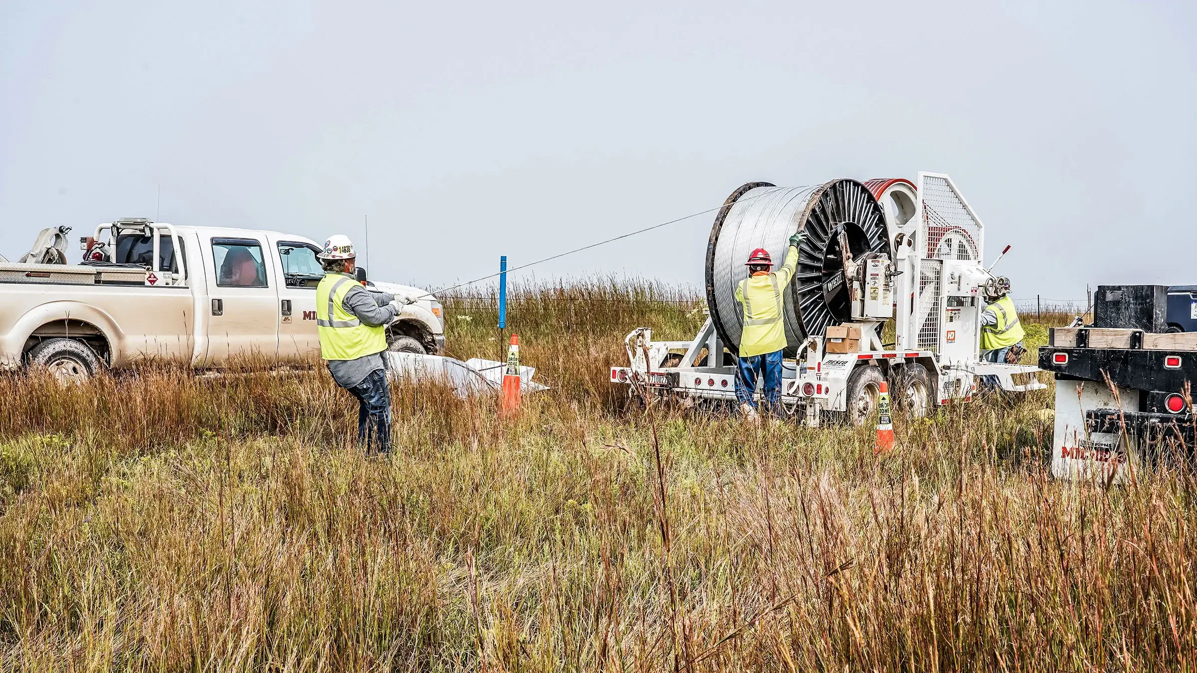Several Michels crew members work together to unravel power cable
