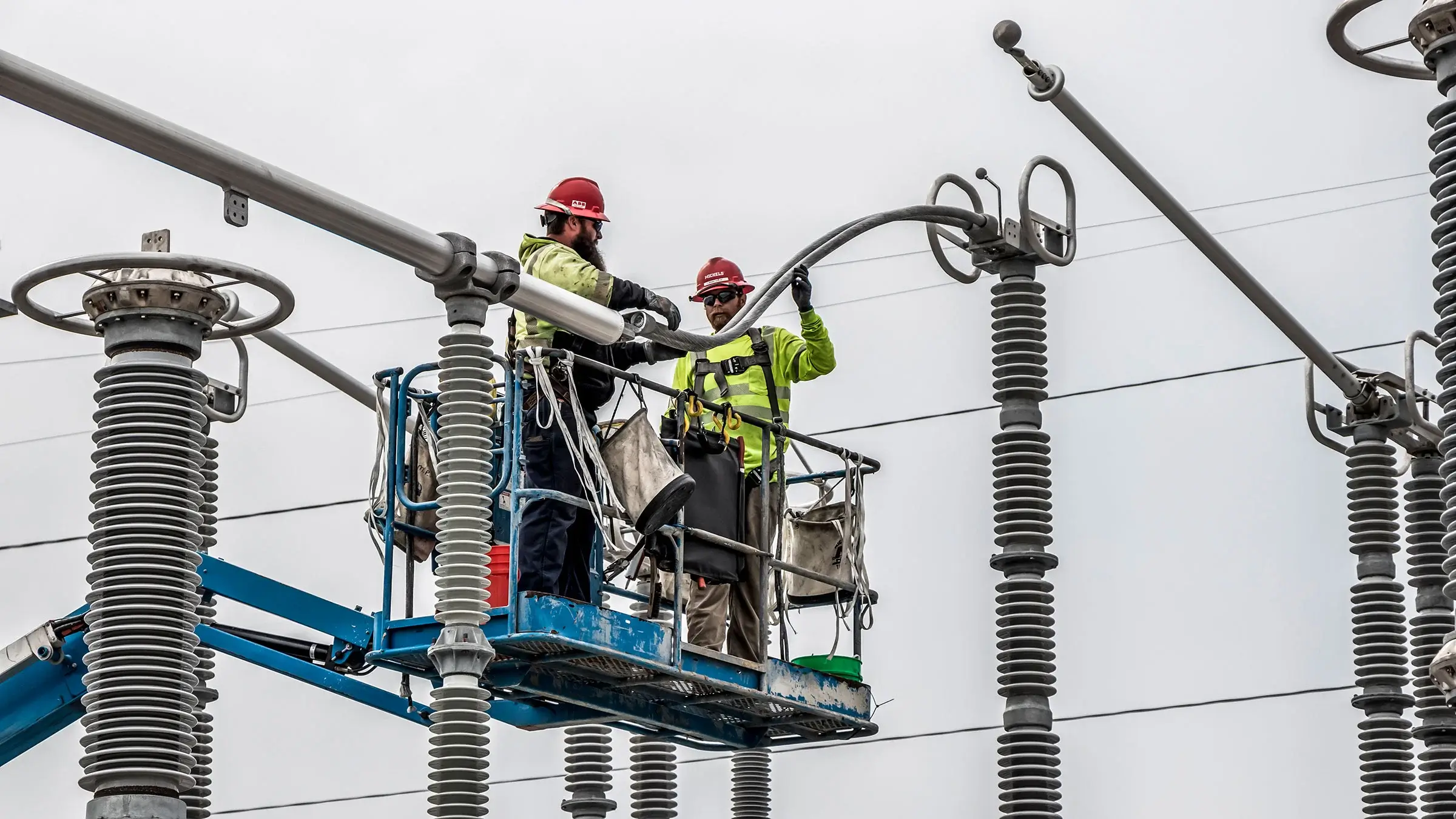 Two Michels Power workers operate on part of the Raccoon Trail substation