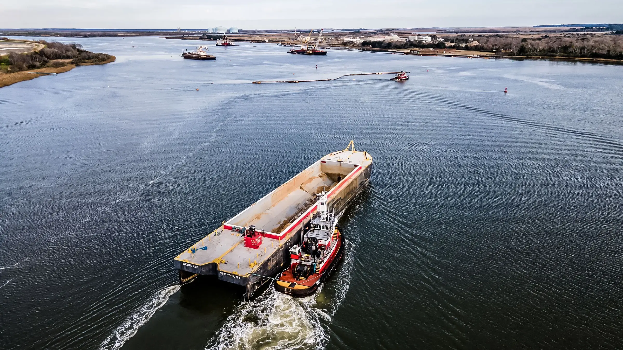 Barge and tugboat working on a river in the Savannah Marsh.