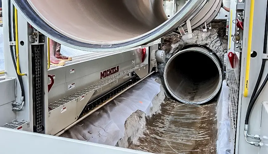 A pipe is placed inside a deteriorating tunnel using sliplining