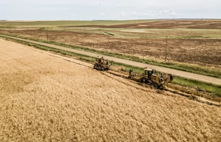 Underground cable is installed in a rural Montana field near a road.