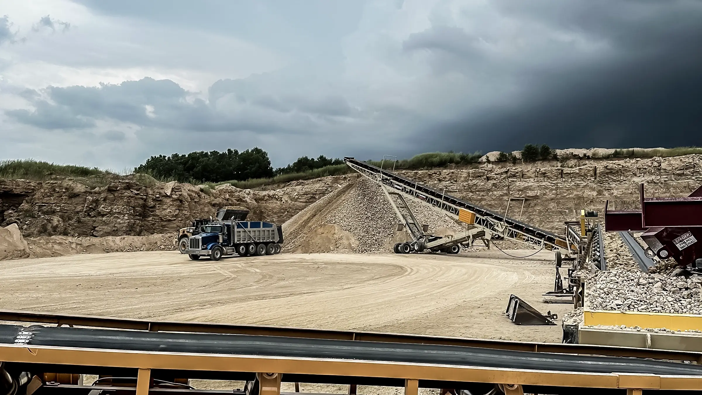 A dump truck at an aggregate loading facility.