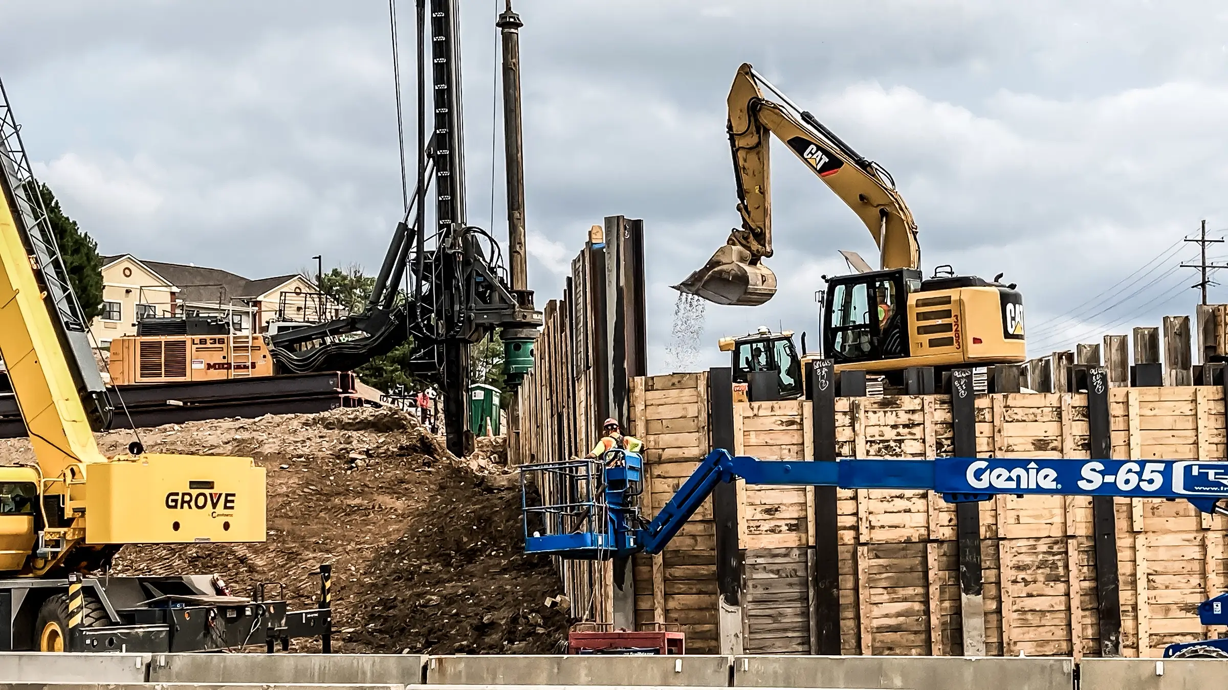 Foundations being installed near a earth retention wall.