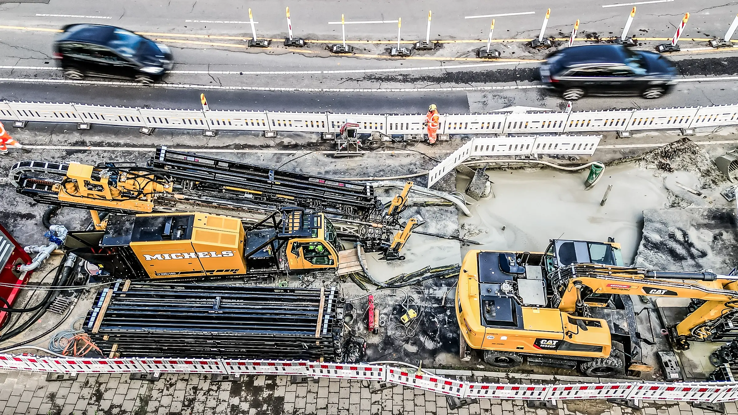 Horizontal directional drill rig operates near a busy German roadside.