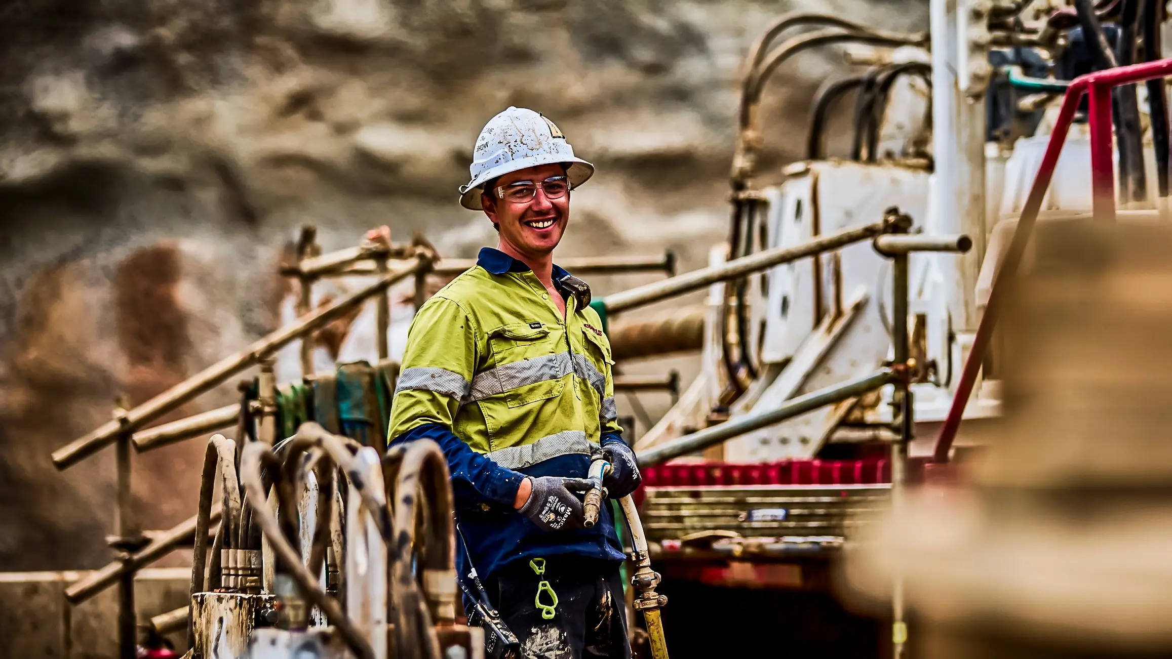 A man smiling near an HDD machine.
