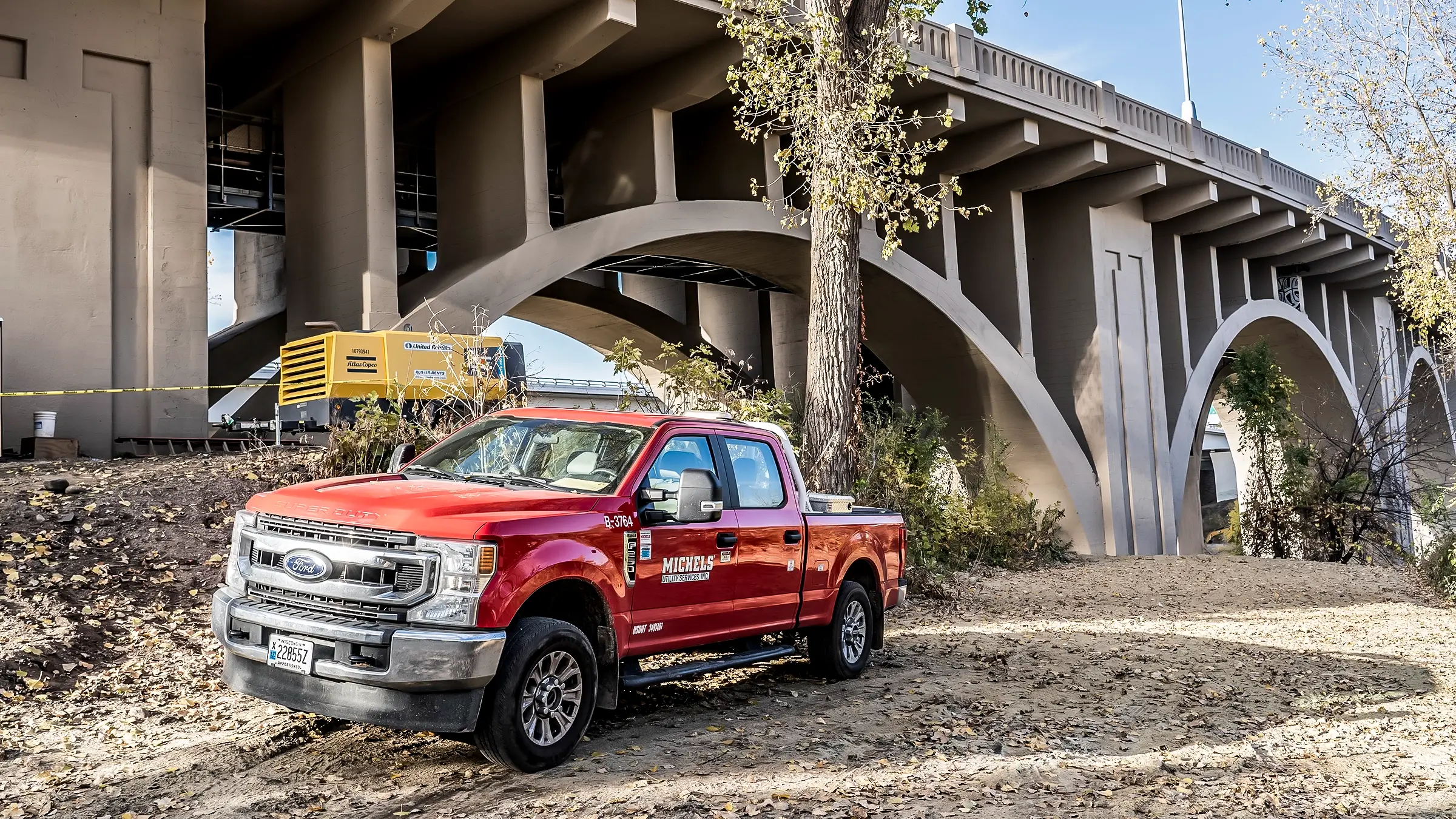 A red Michels pickup truck sits near the 10th Ave bridge in Minnesota.