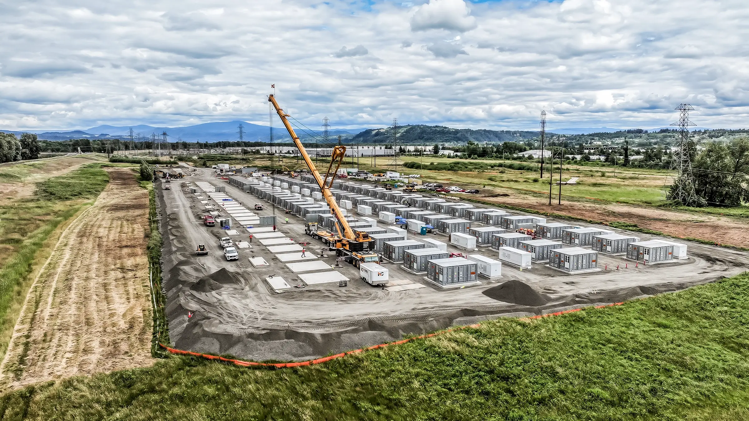 Battery Energy Storage System project location featuring a crane and many system storages.